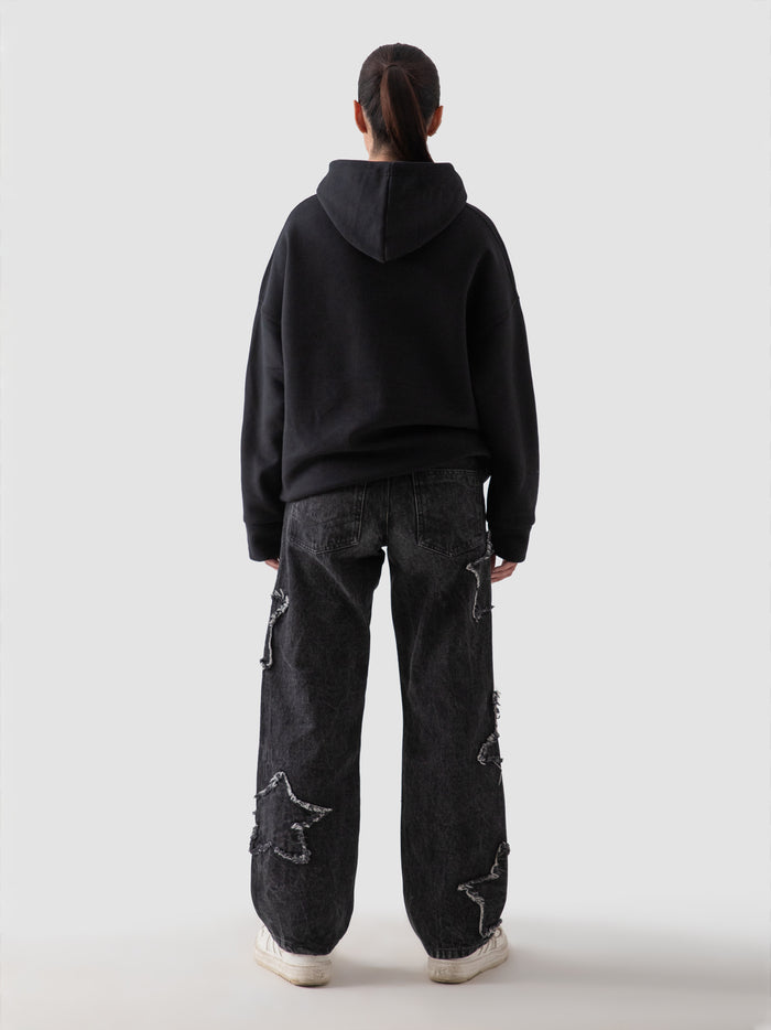 Black oversized hoodie seated lifestyle shot streetwear Pakistan – GROOVY