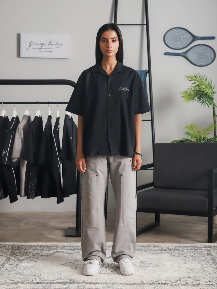 Black Cuban shirt male model seated lifestyle Pakistan – GROOVY