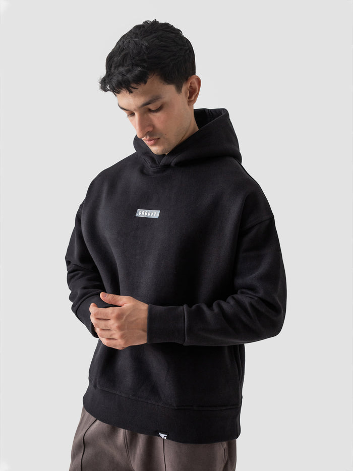 Black oversized hoodie back view relaxed fit Pakistani streetwear – GROOVY