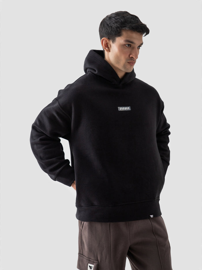 Couple wearing black oversized hoodie lifestyle streetwear Pakistan – GROOVY