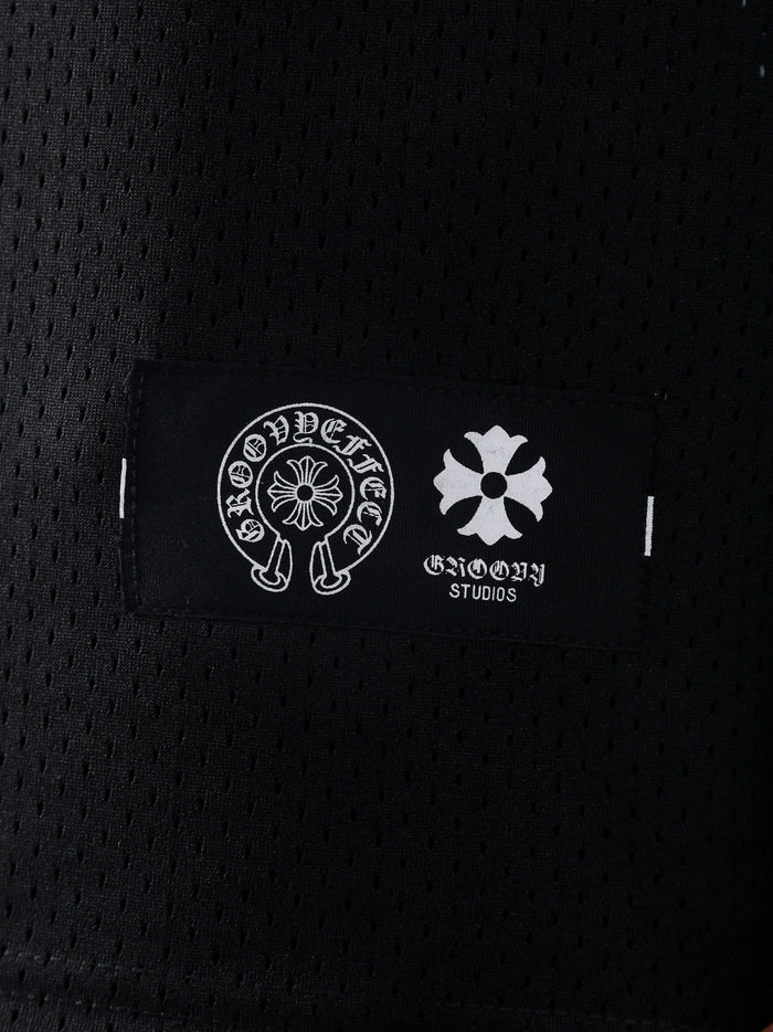 Detailed view of GROOVY's Chrome Hearts-inspired logo label on the black mesh fabric.