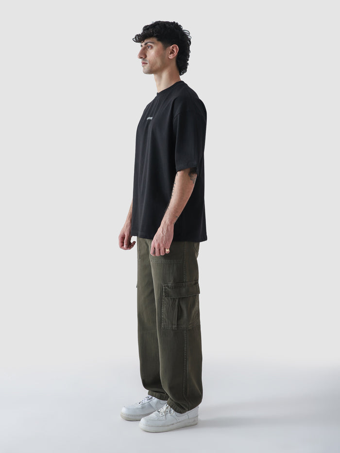Black CORE tee male model back view oversized fit 220 GSM cotton Pakistan – GROOVY