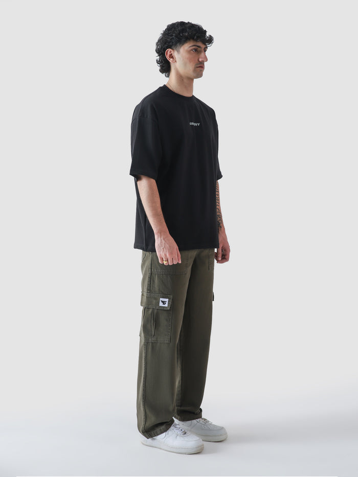 Black essential oversized t-shirt male model side angle streetwear Pakistan – GROOVY