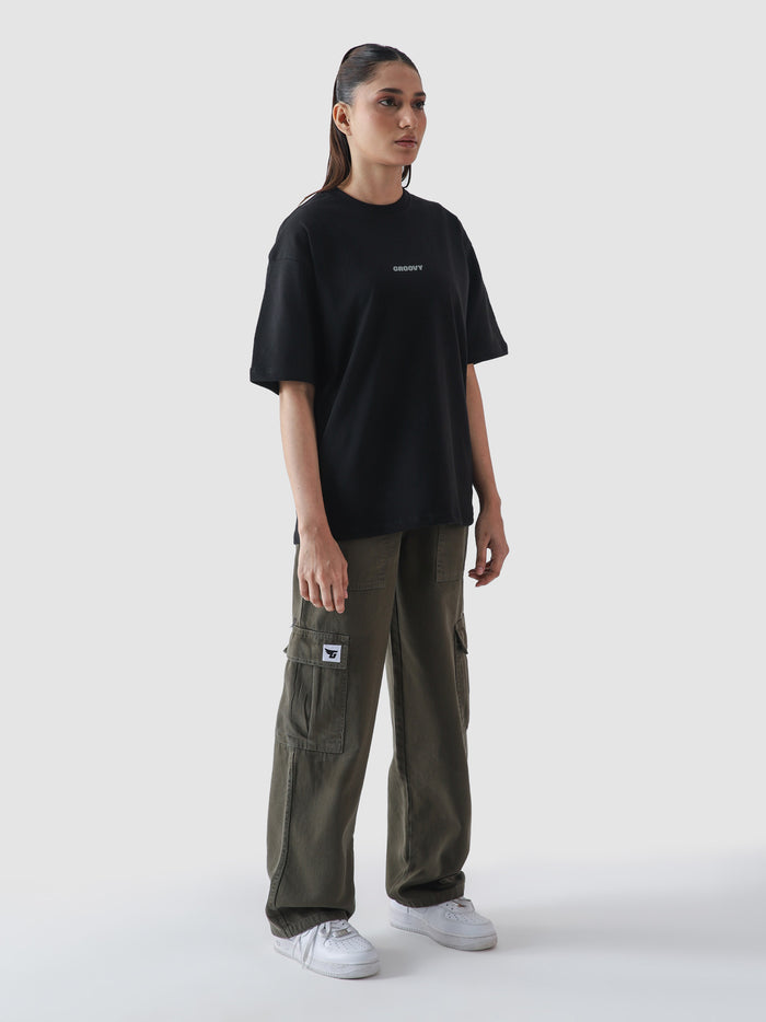 Black essential tee male model outdoor lifestyle shot streetwear Pakistan – GROOVY