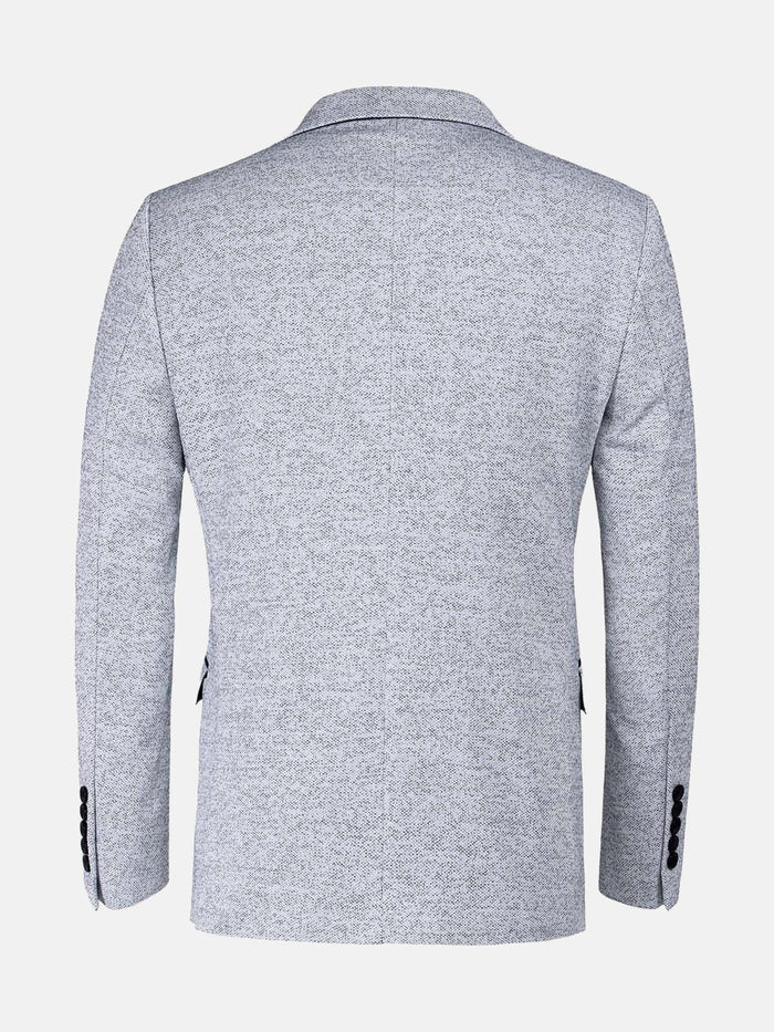 Back view of the white-navy textured blazer showing clean seams and tailored fit.