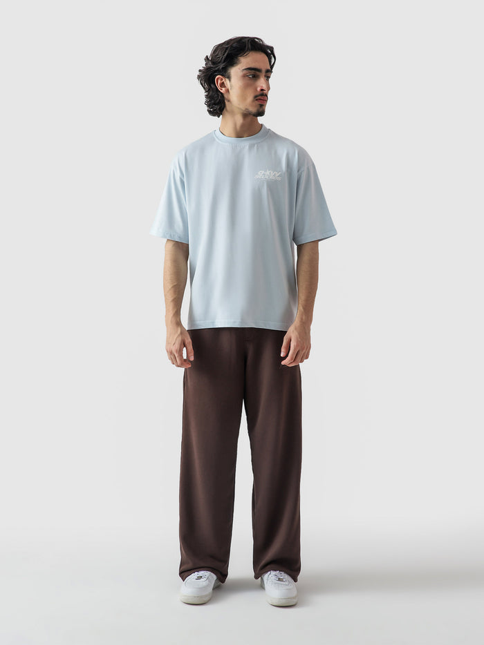 Heart Ashtray frost blue tee male model seated lifestyle Pakistan – GROOVY