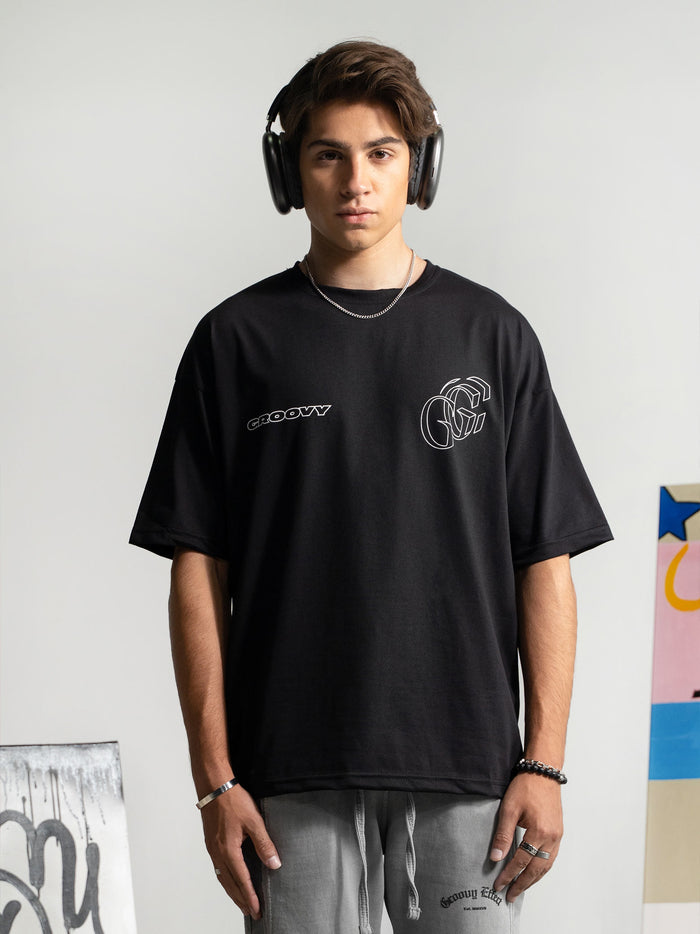 Initial Assembly tee male model side angle black oversized streetwear Pakistan – GROOVY