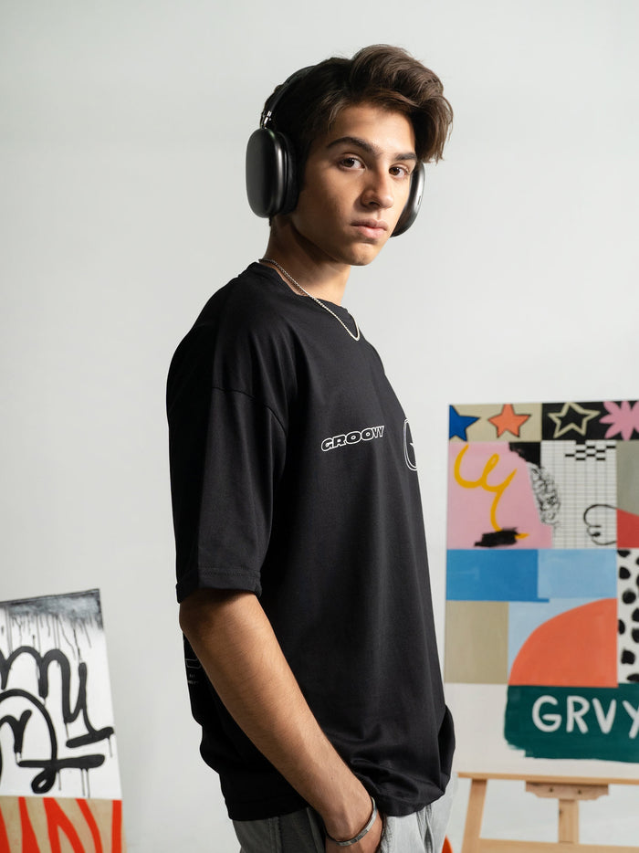Initial Assembly tee flat lay black oversized G logo graphic Pakistan – GROOVY