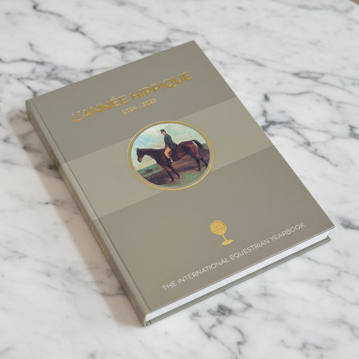Book titled 'L'Année Hippique' on a marble surface