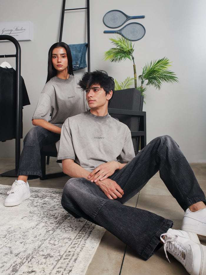Oil fade blank t-shirt male model seated lifestyle shot Pakistan – GROOVY
