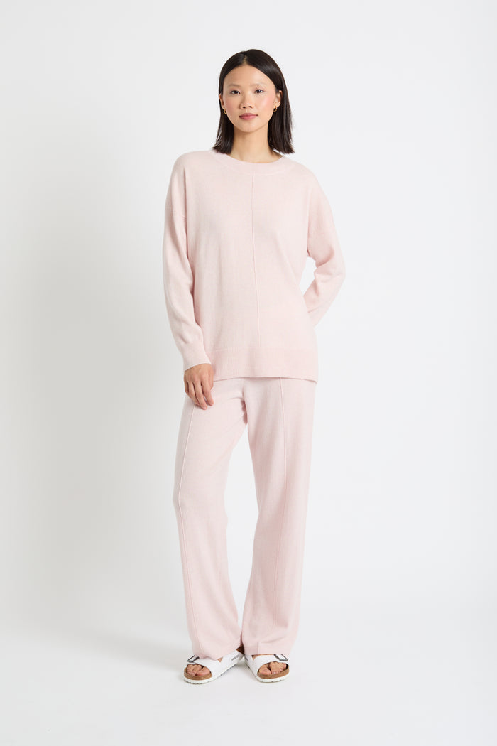 Woman wearing a pink outfit on a white background