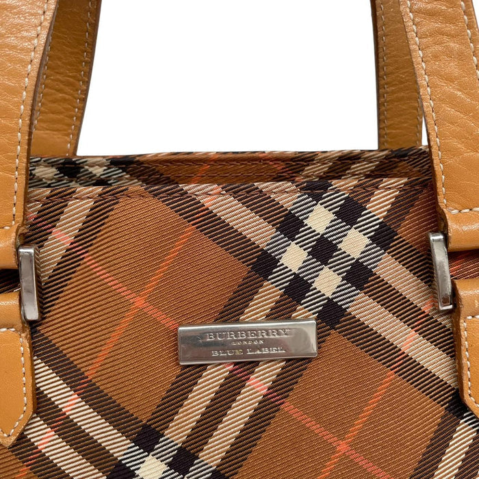Burberry brown duffel bag featuring classic Nova Check pattern and canvas material.