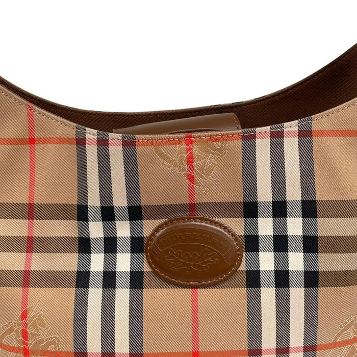 Burberry tan brown duffel bag featuring iconic Nova Check pattern and leather accents.
