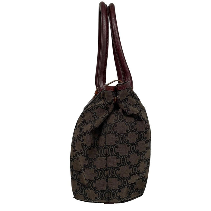 CELINE brown duffel bag with Macadam Triomphe pattern and canvas material.
