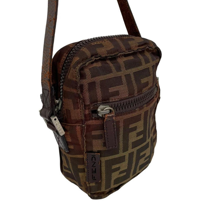 Fendi brown duffel bag with monogram canvas, visible wear and cracking on strap.