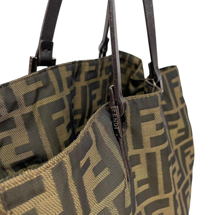 Fendi brown duffel bag featuring iconic Zucca monogram canvas and leather handles.