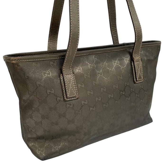 Gucci khaki green duffel bag with metallic monogram canvas and leather trim details.
