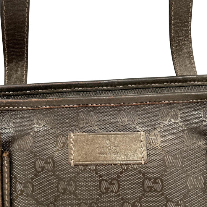 Gucci khaki green duffel bag with metallic monogram canvas and leather trim details.