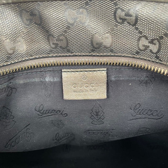 Gucci khaki green duffel bag with metallic monogram canvas and leather trim details.