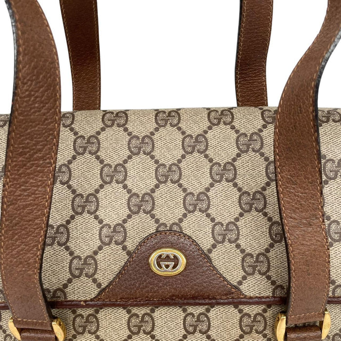 Gucci brown duffel bag with monogram canvas and top handle design.