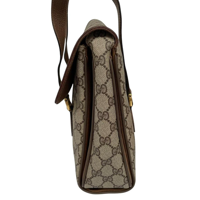 Gucci brown duffel bag with monogram canvas and top handle design.