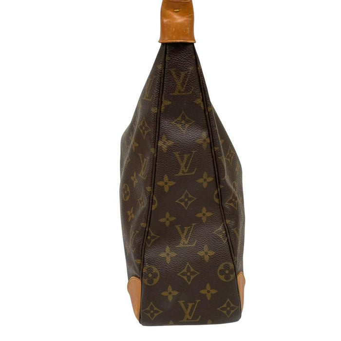 Louis Vuitton brown and tan monogram canvas duffel bag with leather accents and logo.