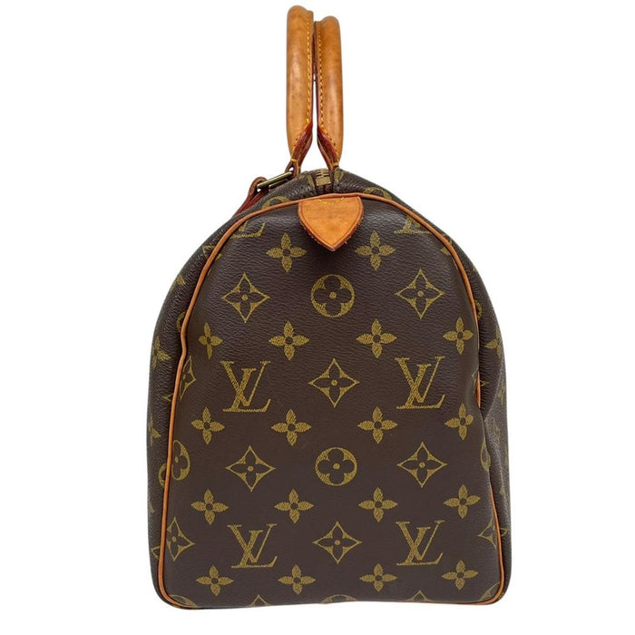 Louis Vuitton duffel bag beige and brown monogram coated canvas with leather trim.