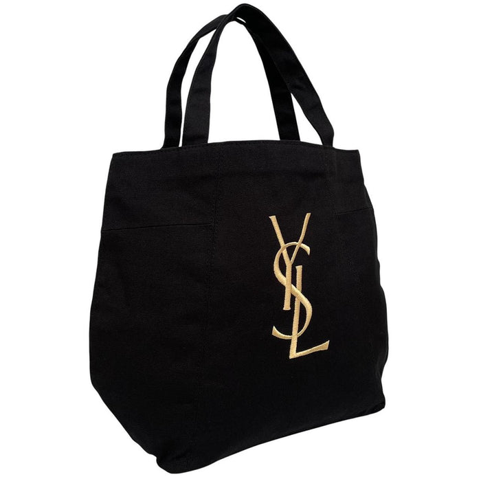 Yves Saint Laurent black duffel bag with gold embroidery and logo detail.