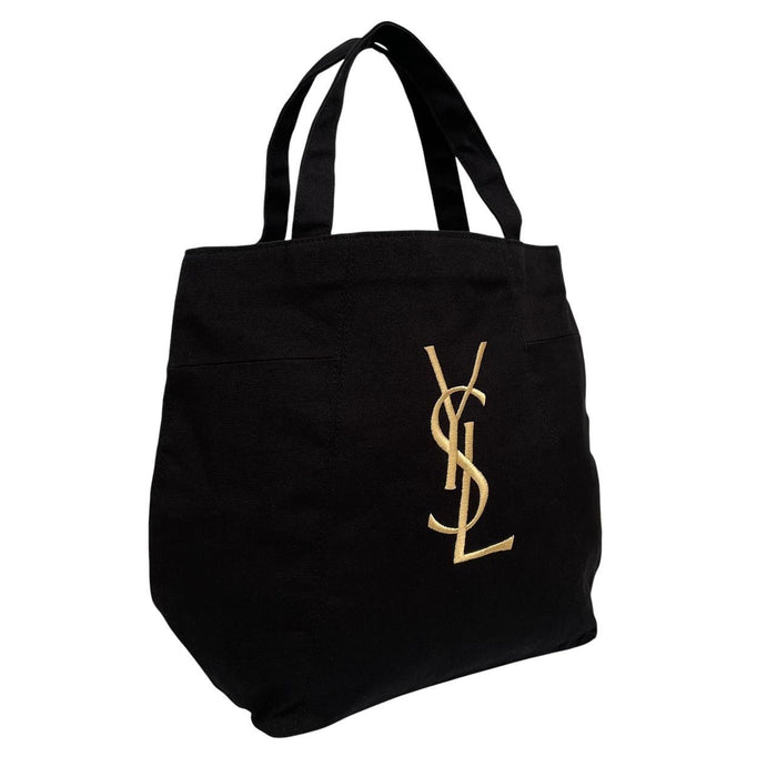 Yves Saint Laurent black duffel bag with gold embroidery and logo detail.