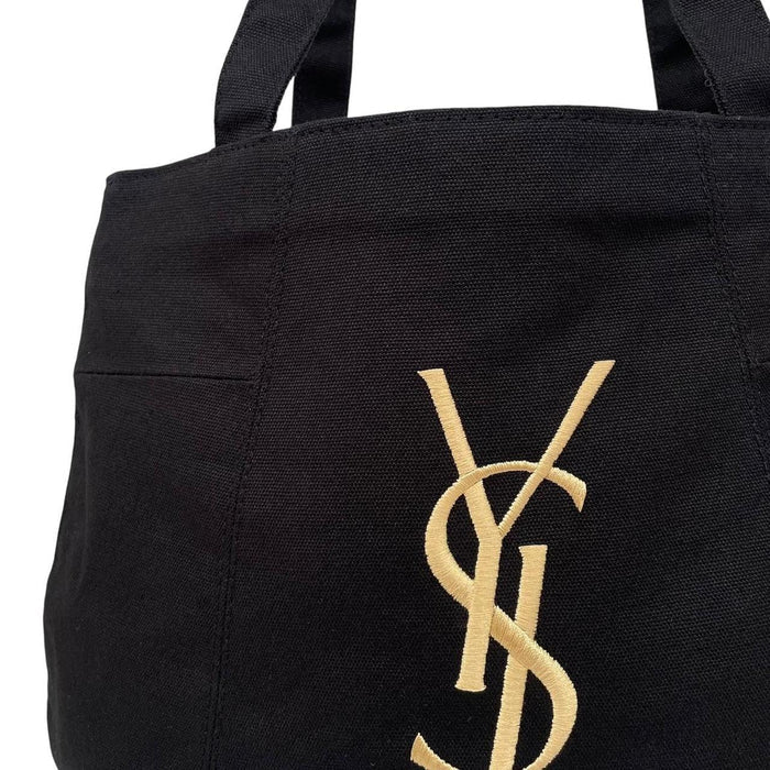 Yves Saint Laurent black duffel bag with gold embroidery and logo detail.