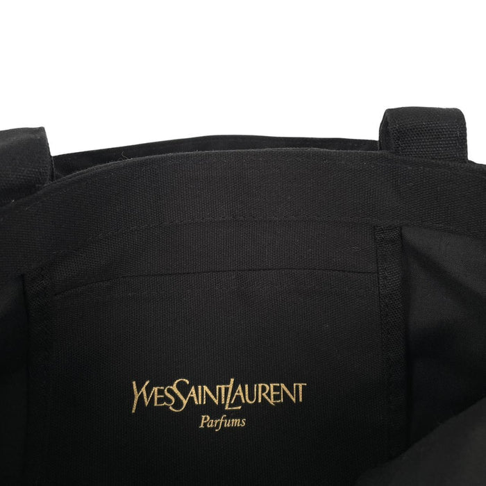 Yves Saint Laurent black duffel bag with gold embroidery and logo detail.