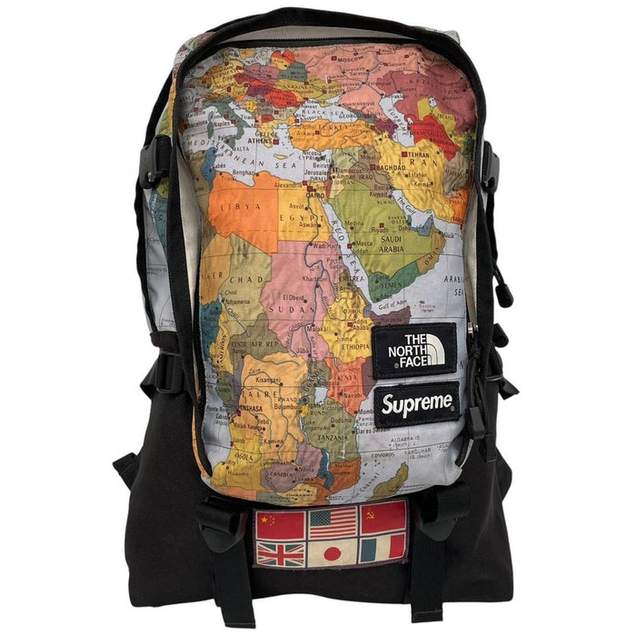 Supreme x The North Face black and multicoloured backpack with logo and scuffed base.