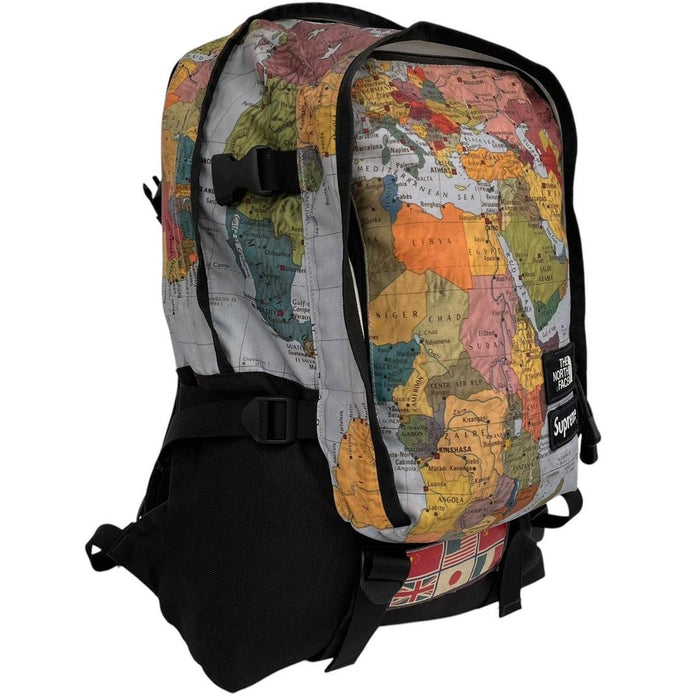 Supreme x The North Face black and multicoloured backpack with logo and scuffed base.