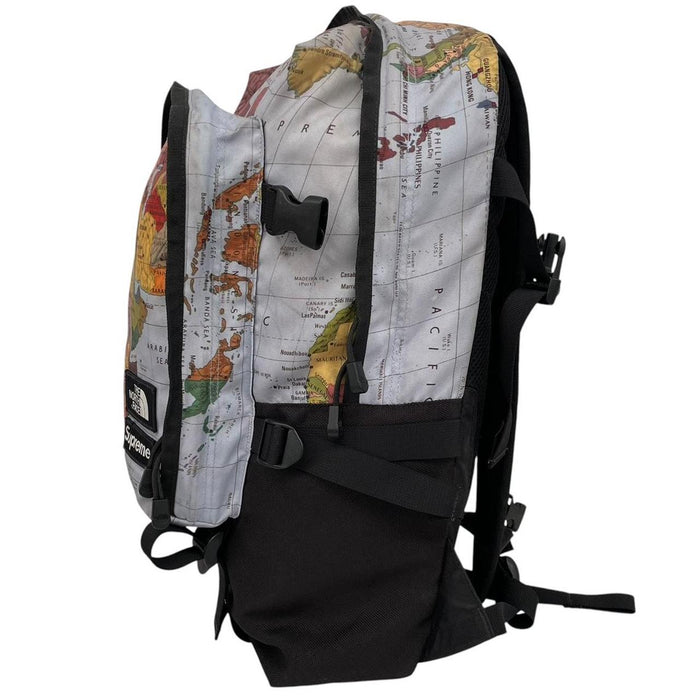 Supreme x The North Face black and multicoloured backpack with logo and scuffed base.