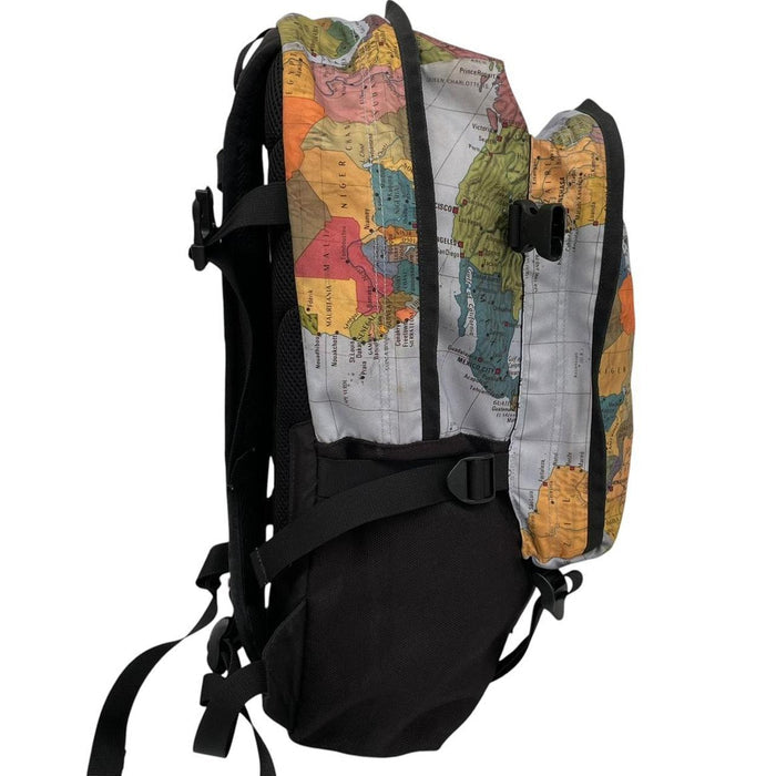 Supreme x The North Face black and multicoloured backpack with logo and scuffed base.