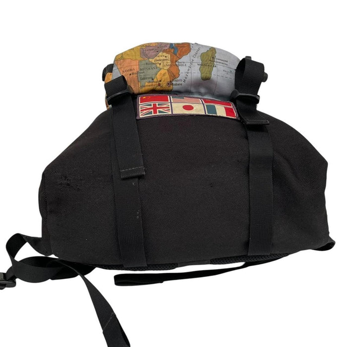 Supreme x The North Face black and multicoloured backpack with logo and scuffed base.