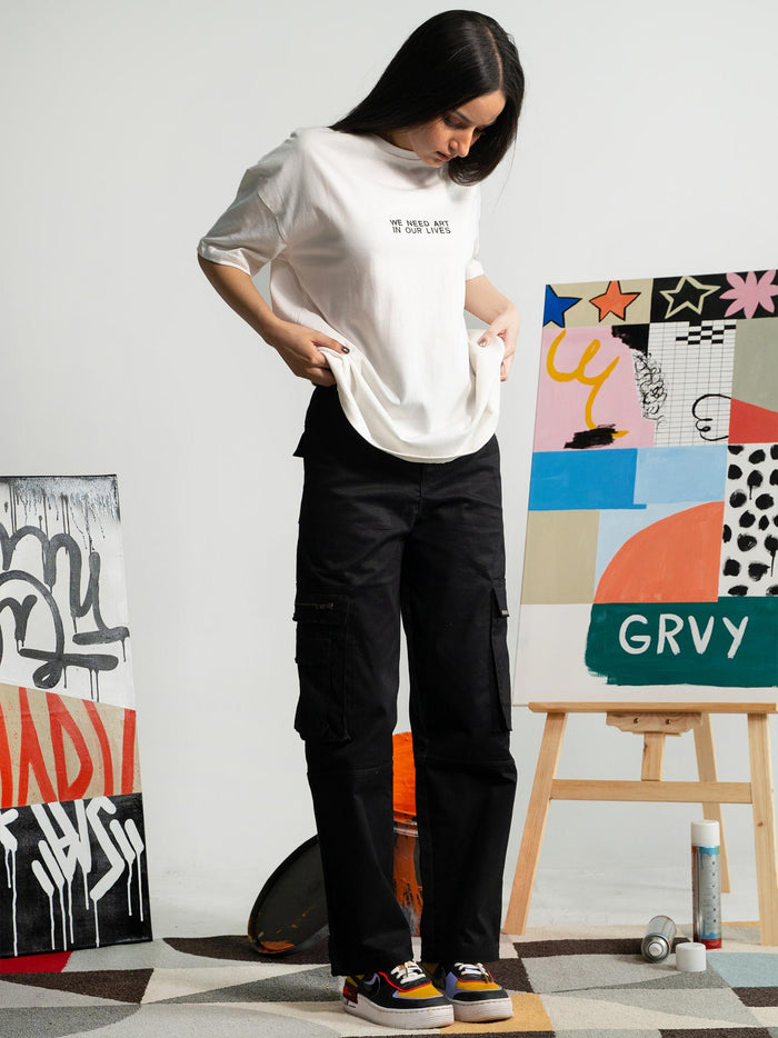 Pearl White Tee Female Model Side View – We Need Art In Our Lives – GROOVY Pakistan